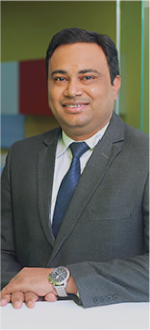 Well-dressed man in a business suit smiling confidently indoors.