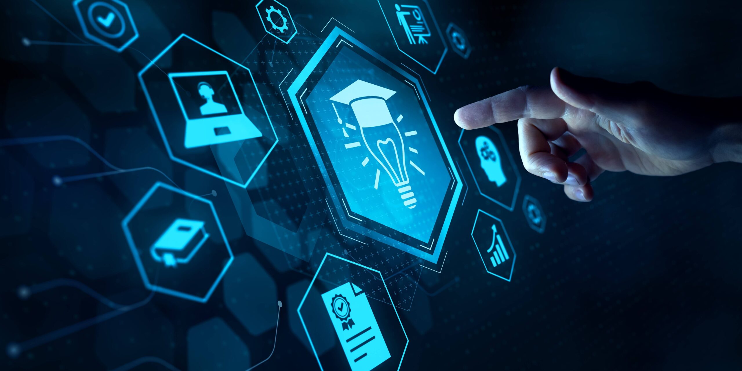 Hand interacting with a digital education interface showing a graduation cap, book, laptop, and technology icons.